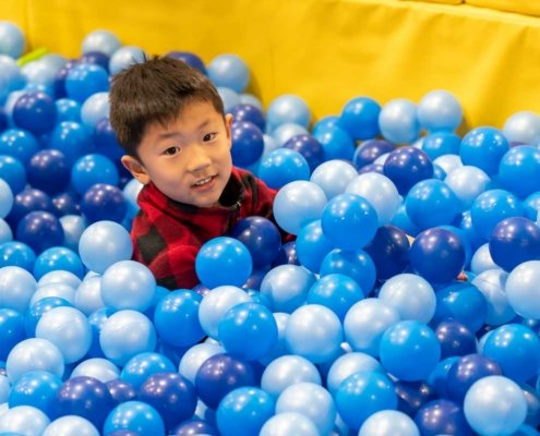 ball-pit boy having fun in an indoor ball pit
