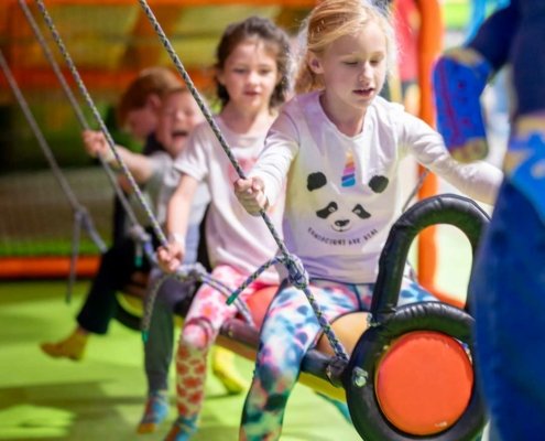 indoor-playground-birthday-party kids playing at an indoor playground during a birthday party