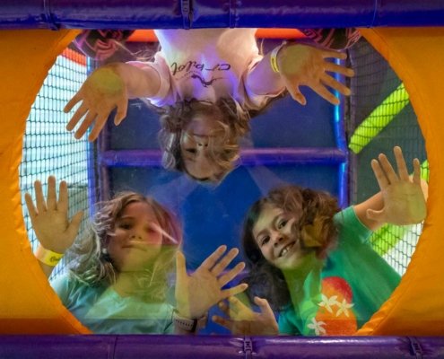 indoor-playhouse three girls looking down from indoor playhouse