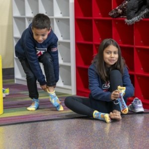 kids putting on socks to play