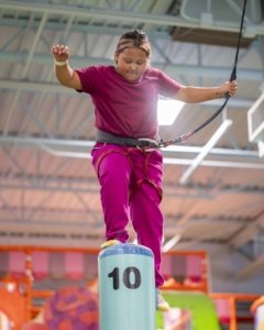 girl climbing colorful obstacle