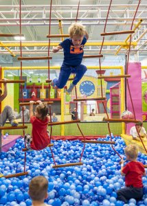 boy playing in ball pit